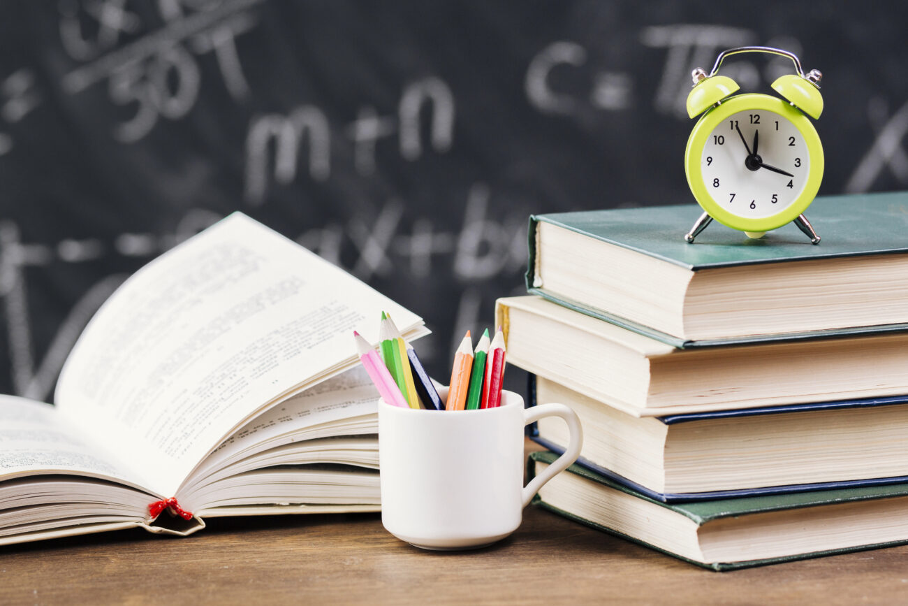 clock top textbooks teacher desk